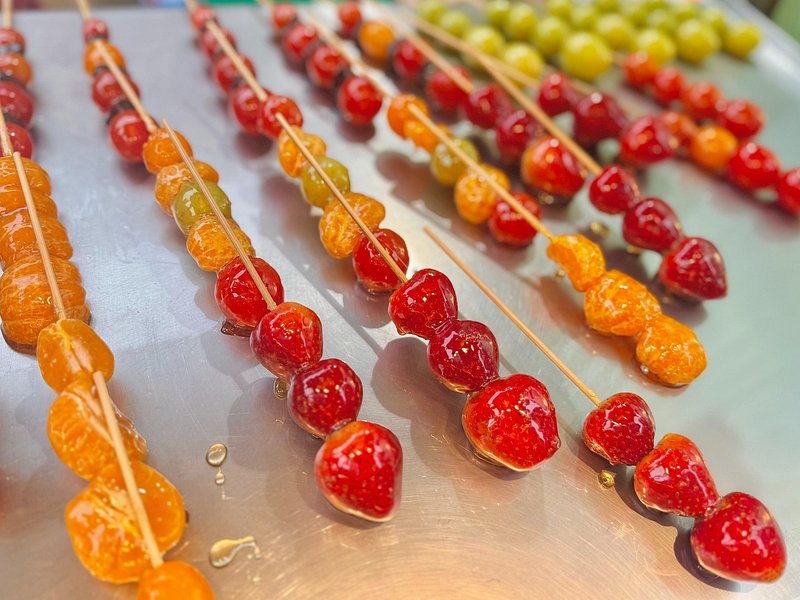 Skewers of candied tomatoes and grapes on a Taipei night market stall