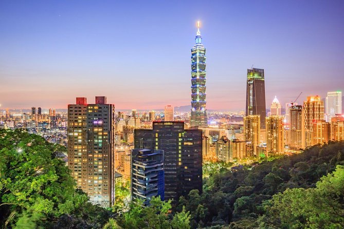 Taipei 101 lit above the Taipei skyline at dusk