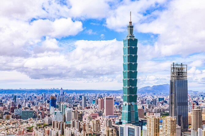 Taipei 101 rising above the rooftops of Taipei under a cloudy sky